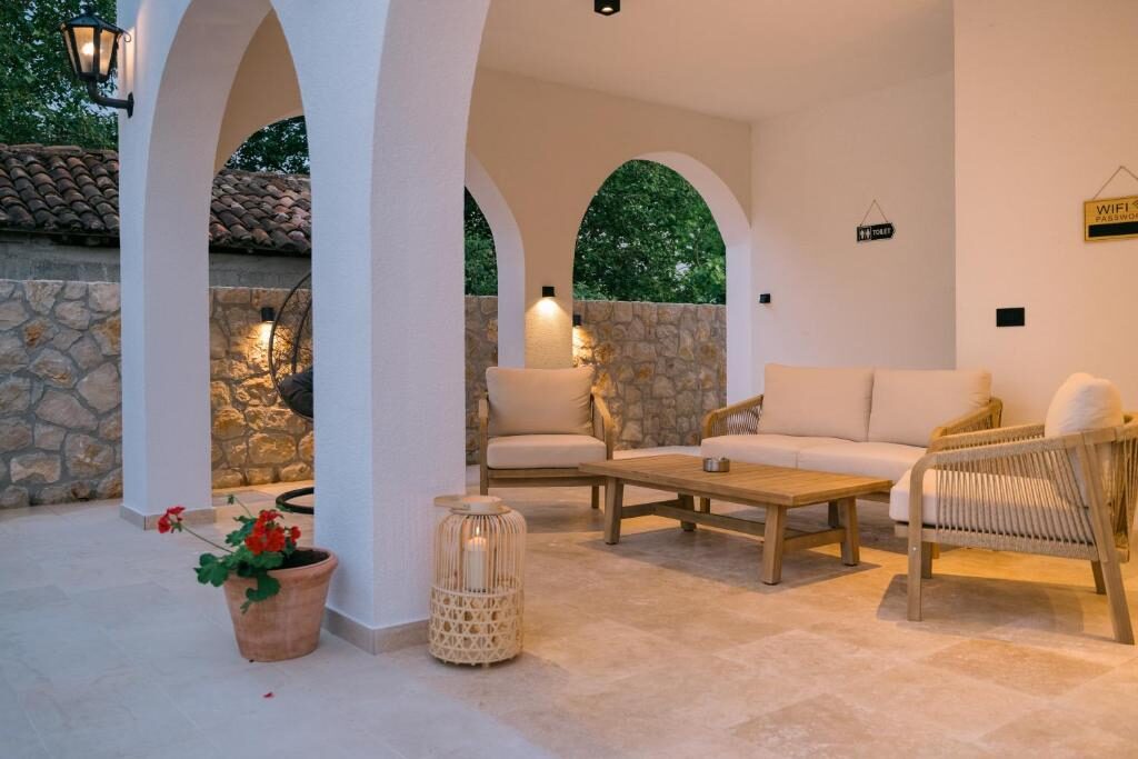 Covered lounge with stone arches at B&B Lovac Pool & Spa
